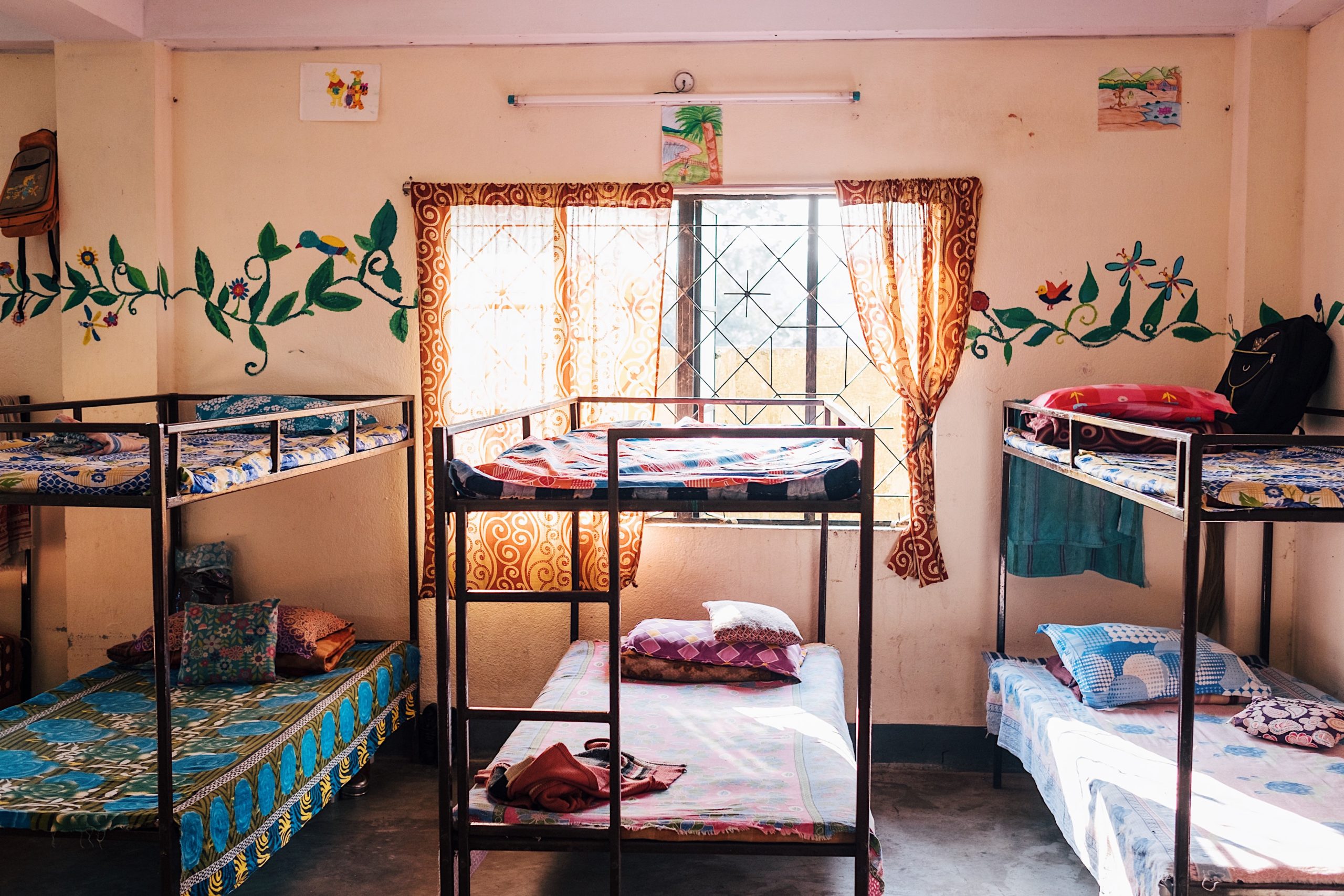 Beds and flower mural wall in shelter home in India
