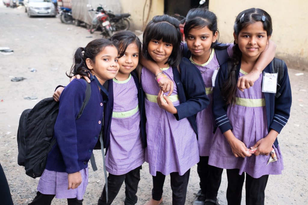 Group of Indian school girls posing for picture in purple uniforms from EkTara Middle School