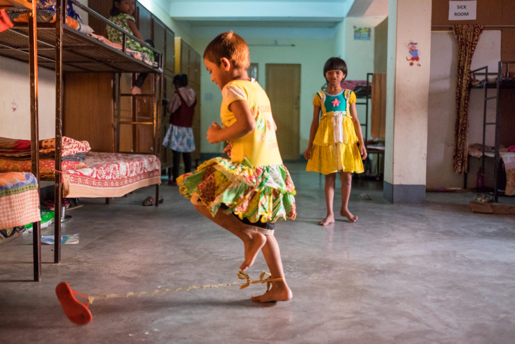 Indian children playing handmade game in shelter home